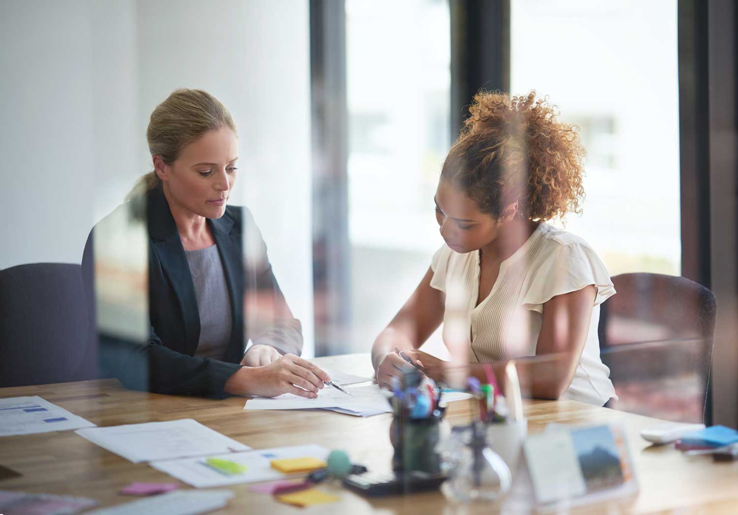 employees at a table reviewing documents